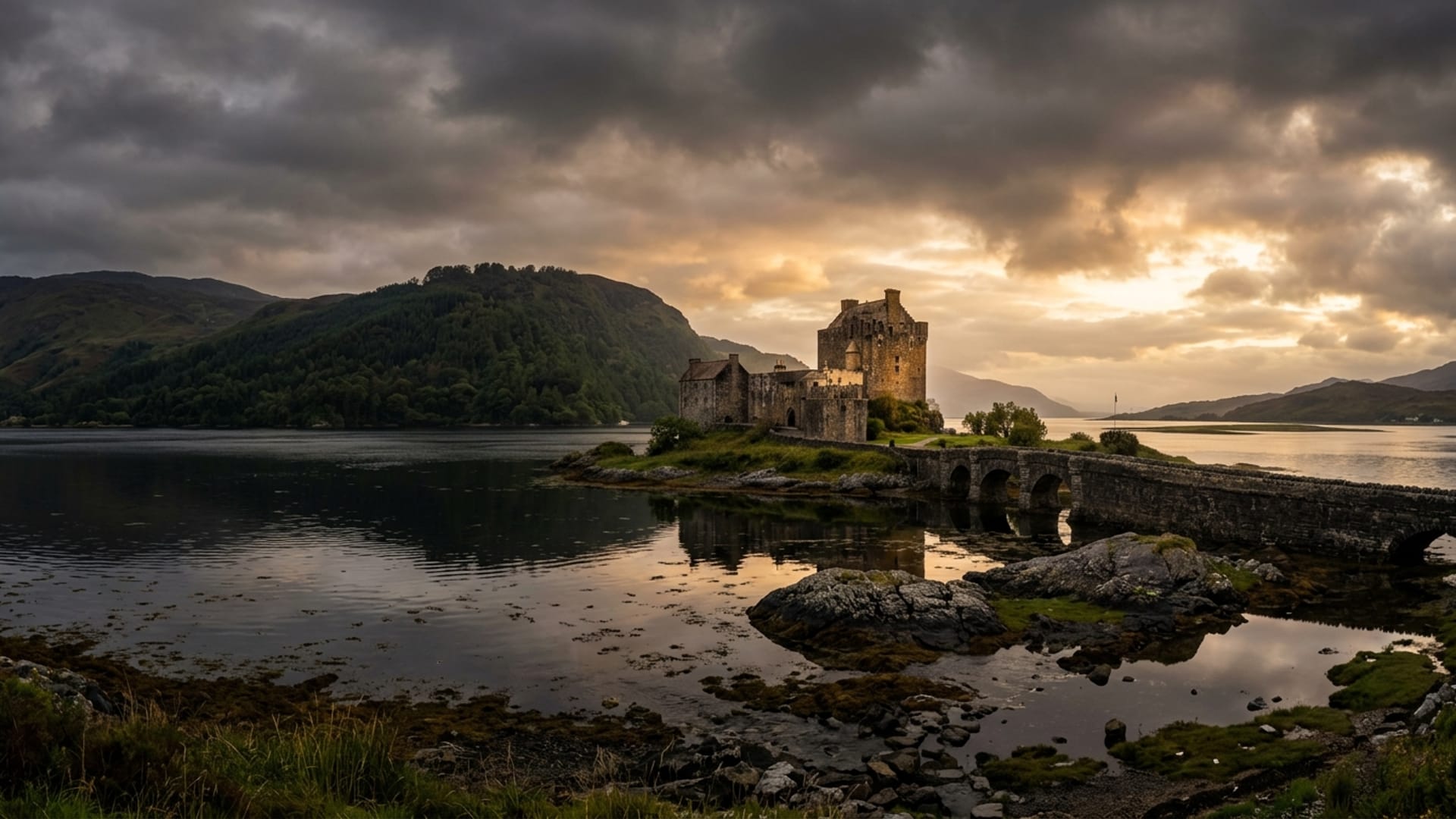 Eilean Donan Castle reflected in the still waters of Loch Duich at dawn, the iconic stone bridge leading to its island